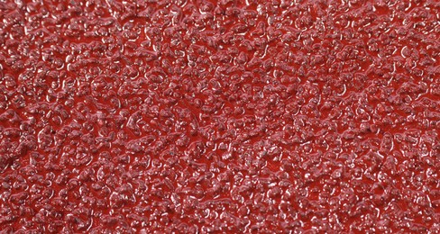 Texture of coarse sandpaper as background, closeup