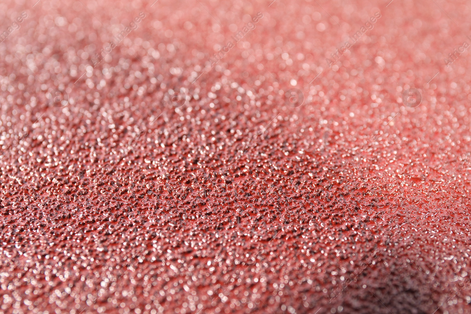 Photo of Texture of coarse sandpaper as background, closeup