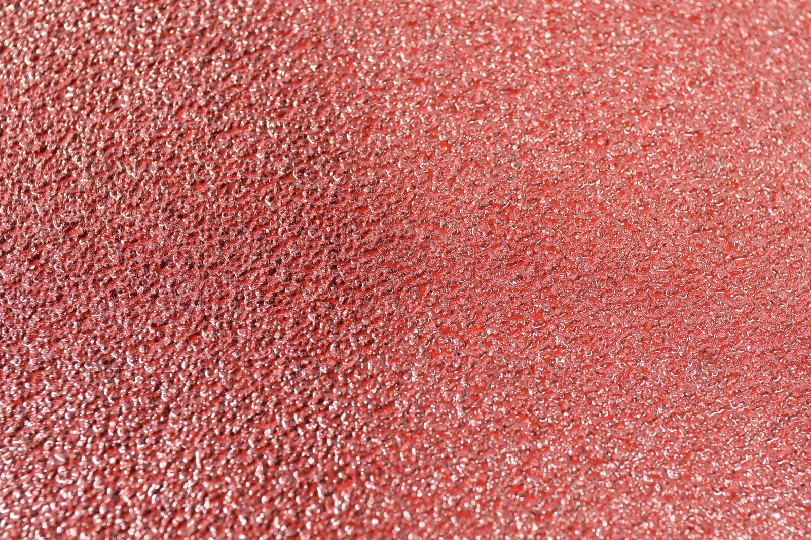 Photo of Texture of coarse sandpaper as background, closeup