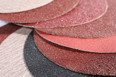 Photo of Many sheets of sandpaper as background, closeup