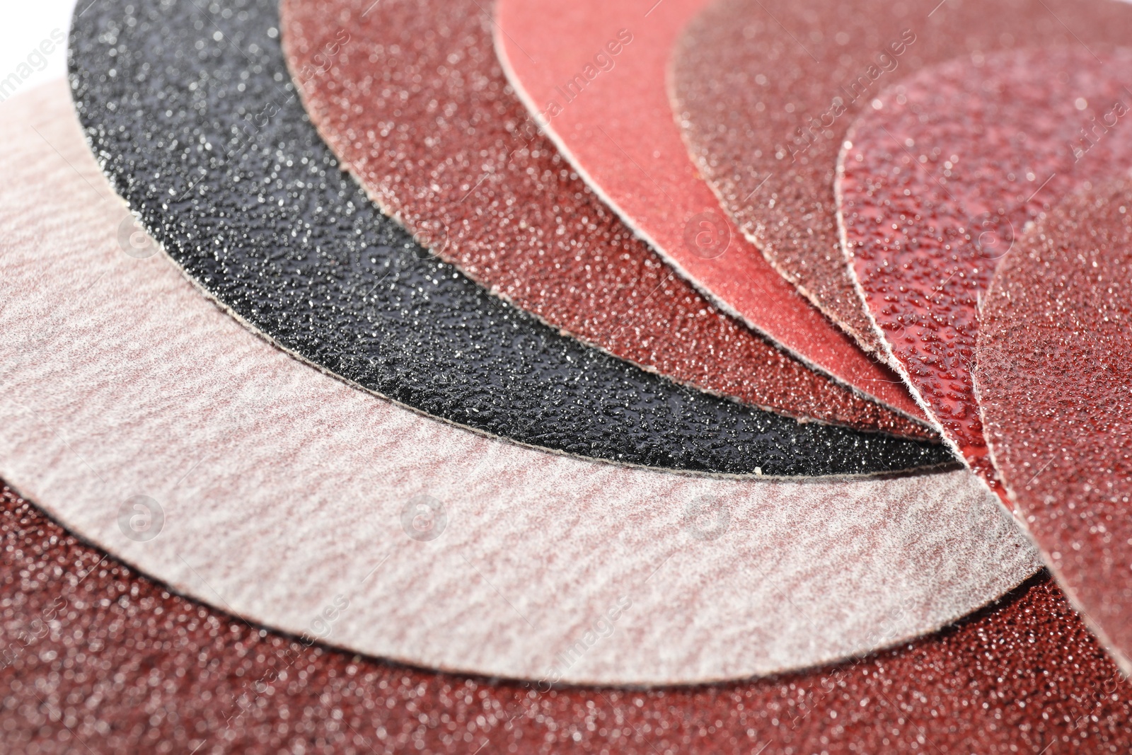 Photo of Many sheets of sandpaper as background, closeup