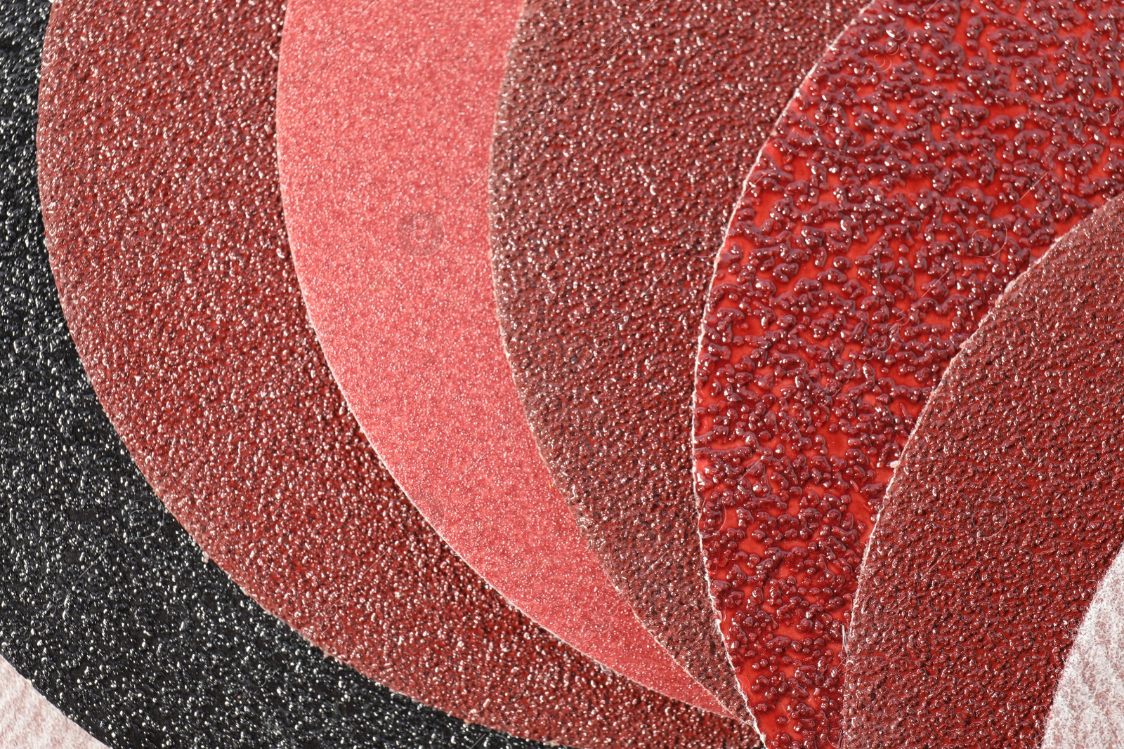 Photo of Many sheets of sandpaper as background, top view