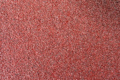 Photo of Texture of coarse sandpaper as background, top view