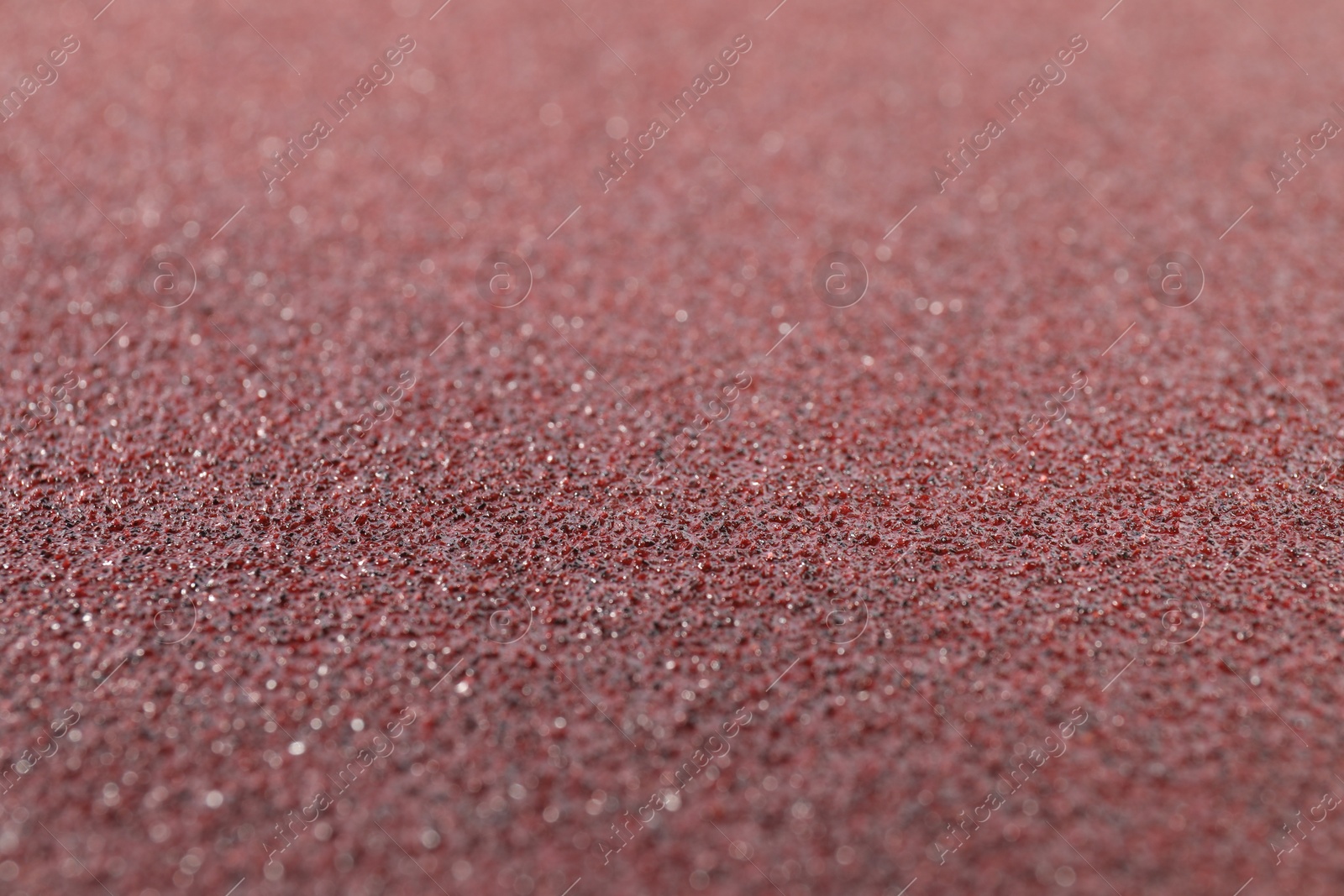 Photo of Texture of coarse sandpaper as background, closeup