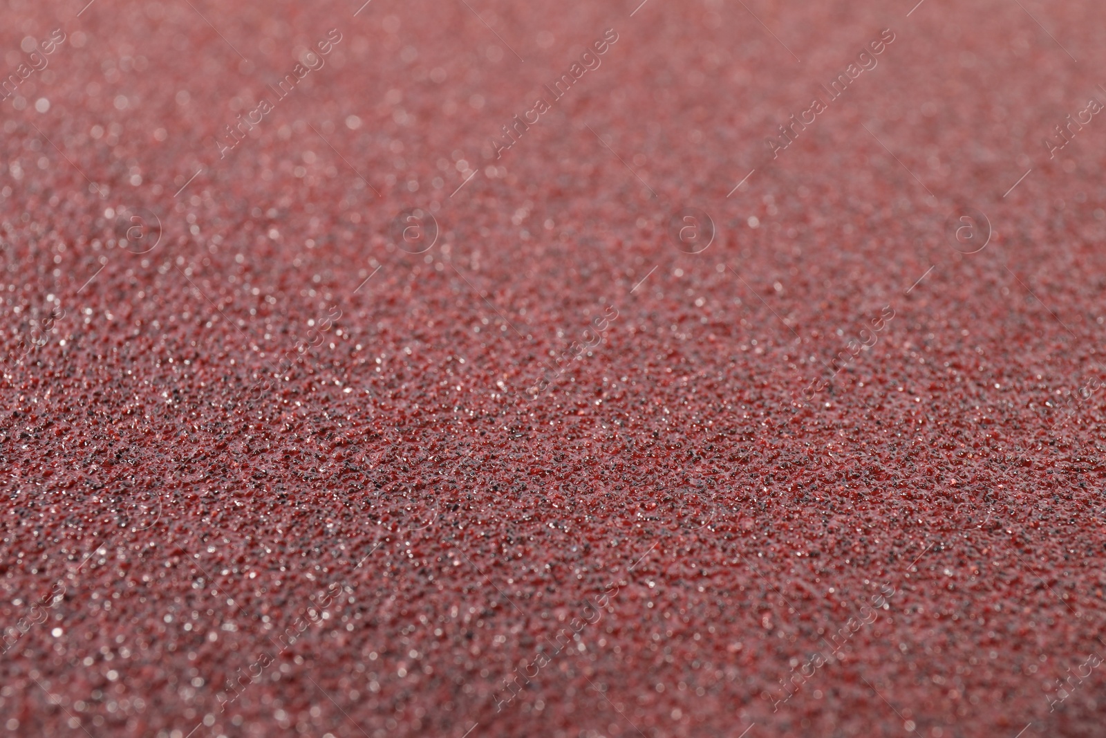 Photo of Texture of coarse sandpaper as background, closeup