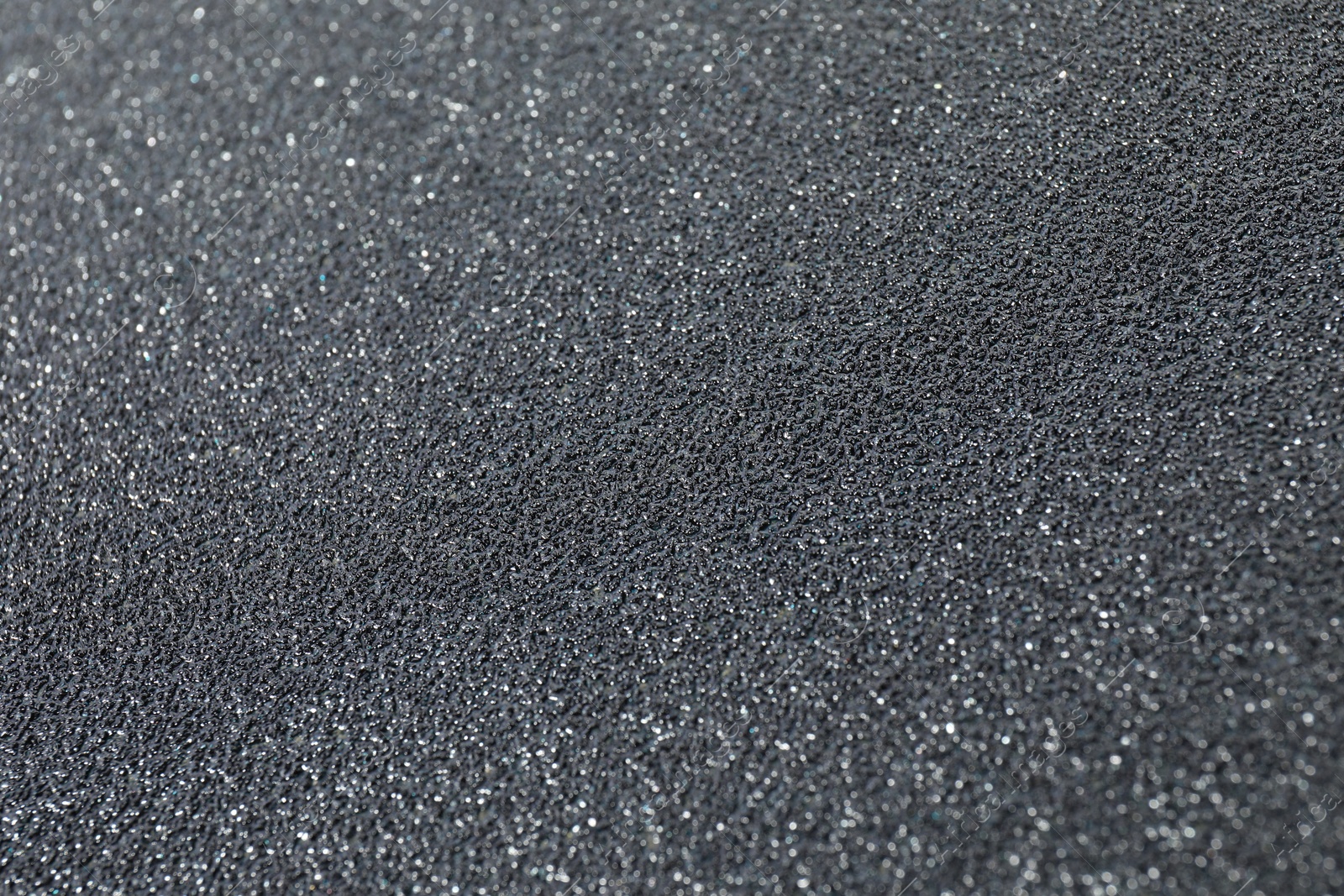 Photo of Texture of coarse sandpaper as background, closeup