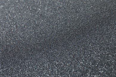 Photo of Texture of coarse sandpaper as background, closeup