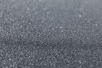 Photo of Texture of coarse sandpaper as background, closeup