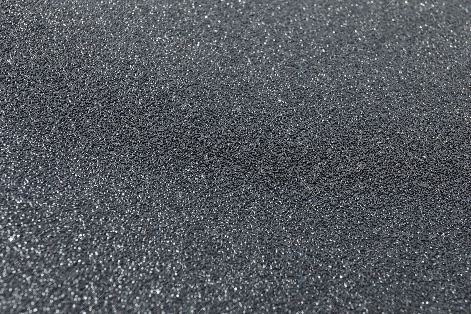 Photo of Texture of coarse sandpaper as background, closeup