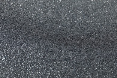 Photo of Texture of coarse sandpaper as background, closeup