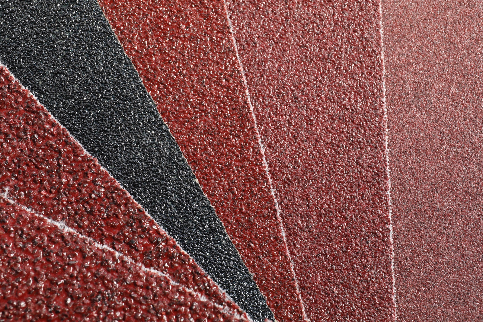 Photo of Many sheets of sandpaper as background, top view