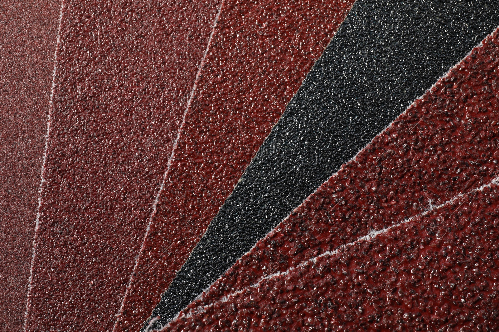 Photo of Many sheets of sandpaper as background, top view