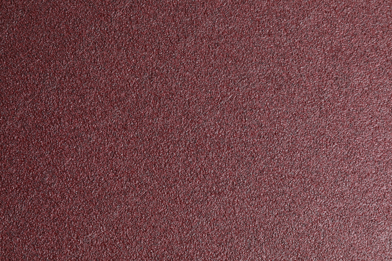 Photo of Texture of coarse sandpaper as background, top view