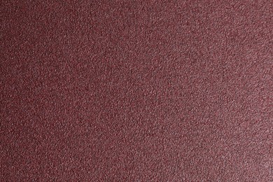 Photo of Texture of coarse sandpaper as background, top view