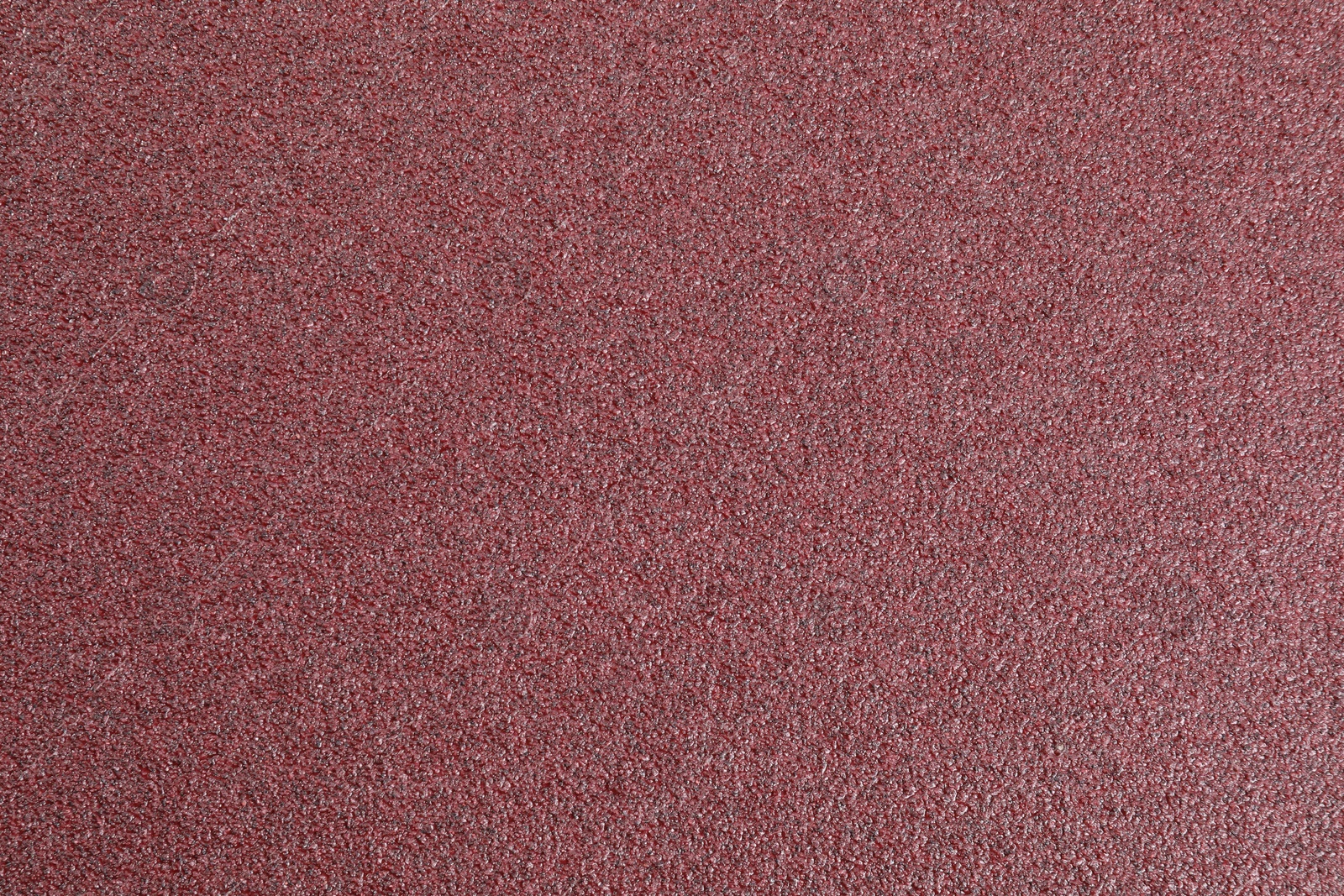 Photo of Texture of coarse sandpaper as background, top view