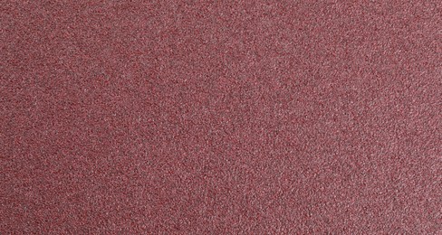 Photo of Texture of coarse sandpaper as background, top view