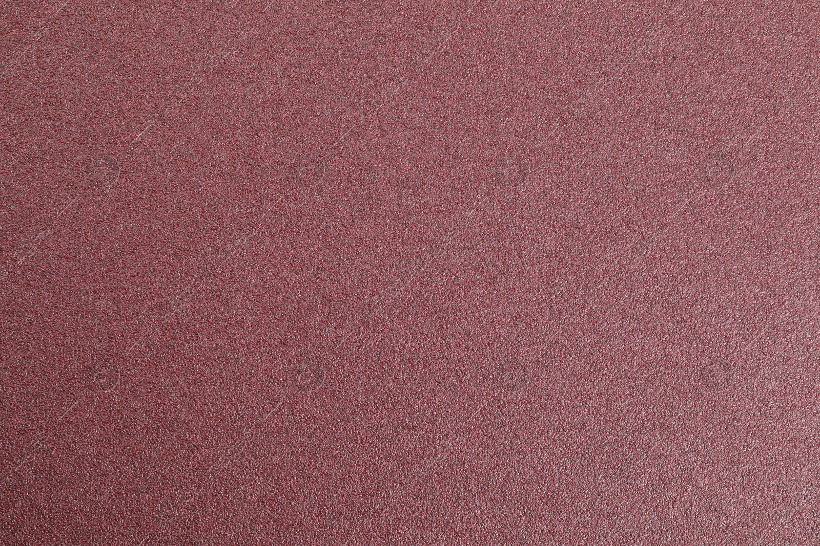 Photo of Texture of coarse sandpaper as background, top view