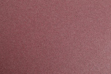 Photo of Texture of coarse sandpaper as background, top view