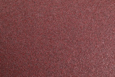 Photo of Texture of coarse sandpaper as background, top view