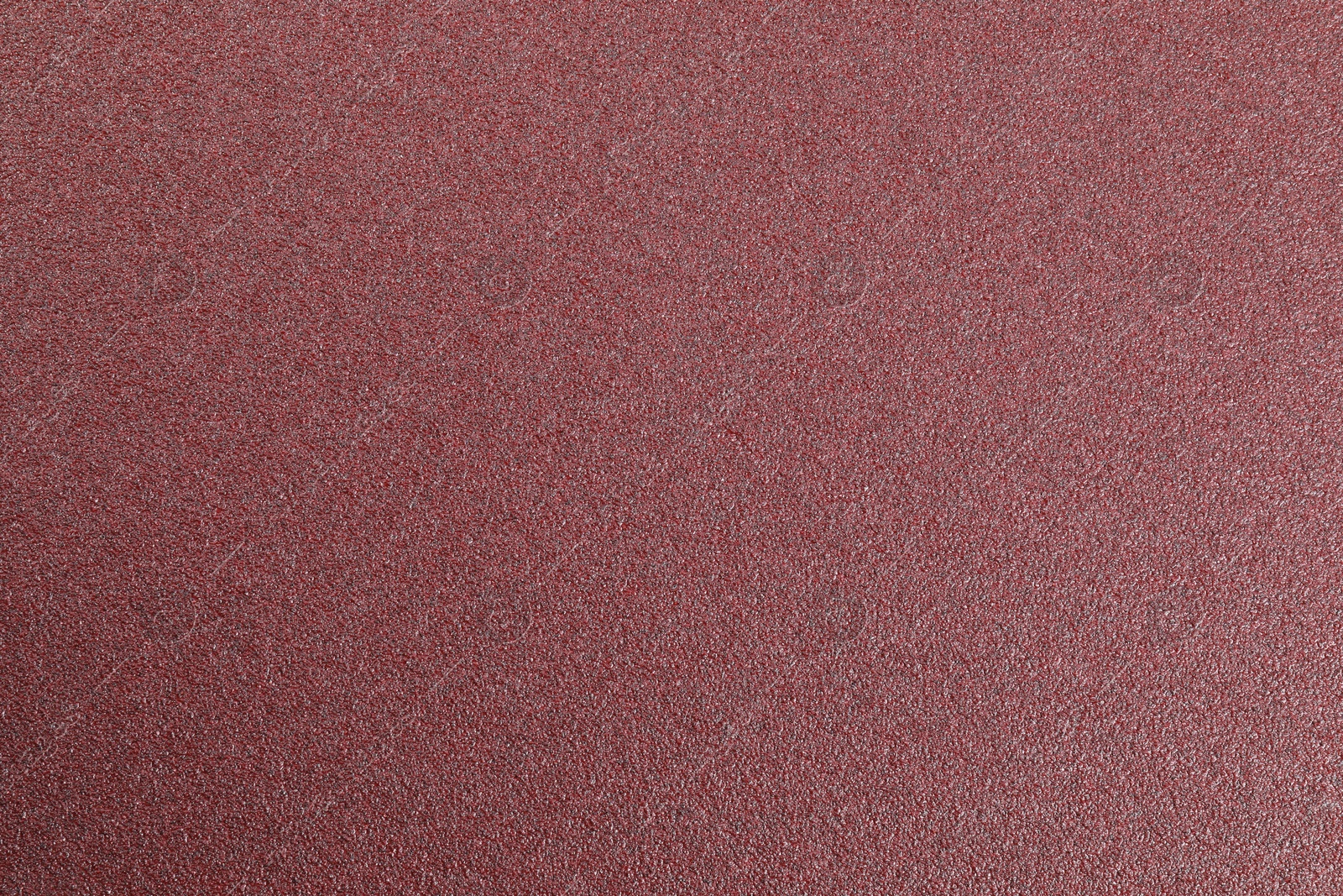 Photo of Texture of coarse sandpaper as background, top view