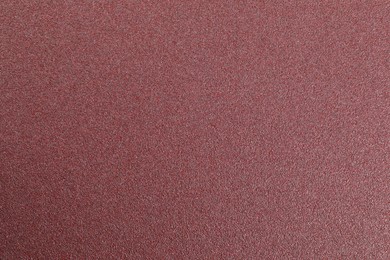 Texture of coarse sandpaper as background, top view