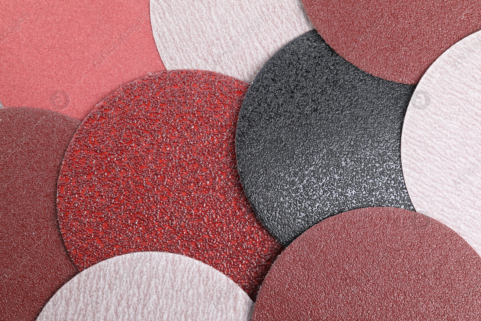 Photo of Coarse sandpaper disks as background, top view