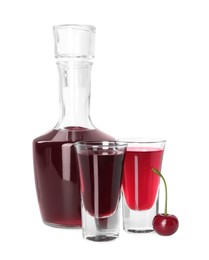 Photo of Bottle and shot glasses of delicious cherry liqueur isolated on white