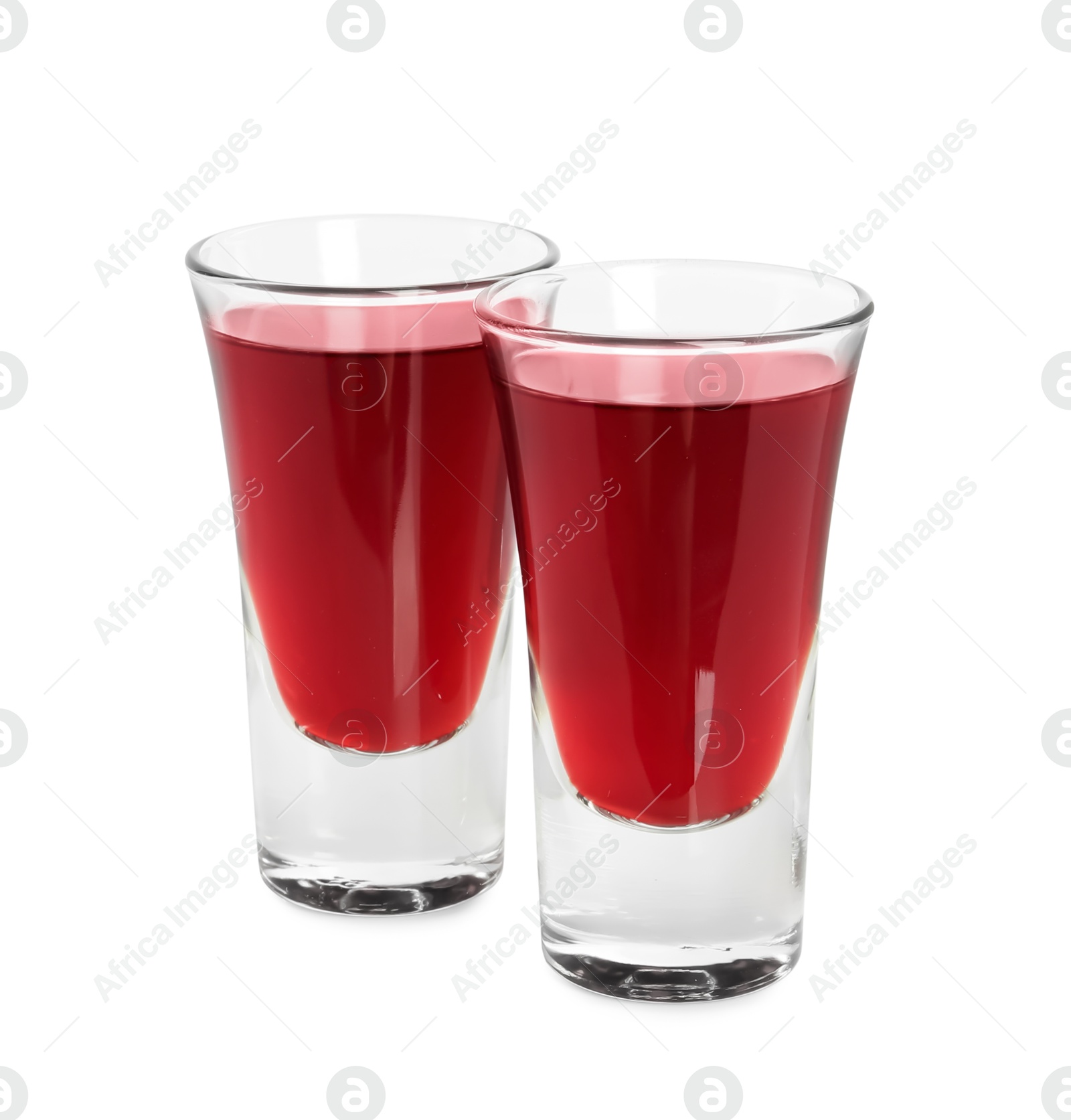 Photo of Shot glasses of delicious cherry liqueur isolated on white
