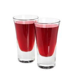Photo of Shot glasses of delicious cherry liqueur isolated on white