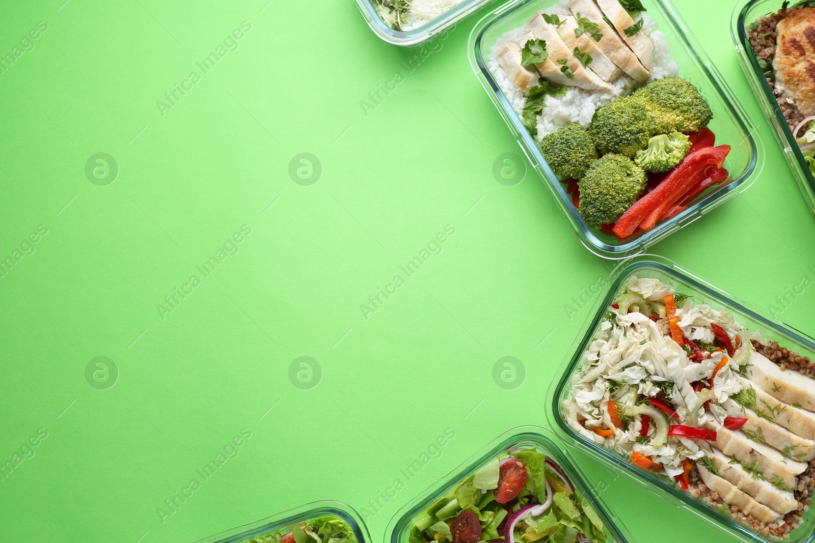 Photo of Healthy food. Different meals in glass containers on green background, flat lay. Space for text