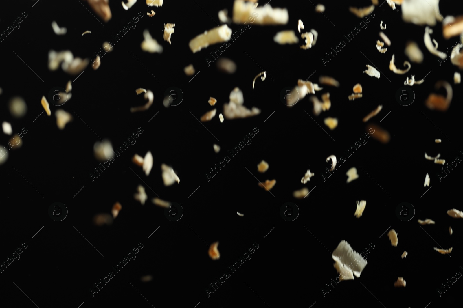 Photo of Dry natural sawdust falling on black background