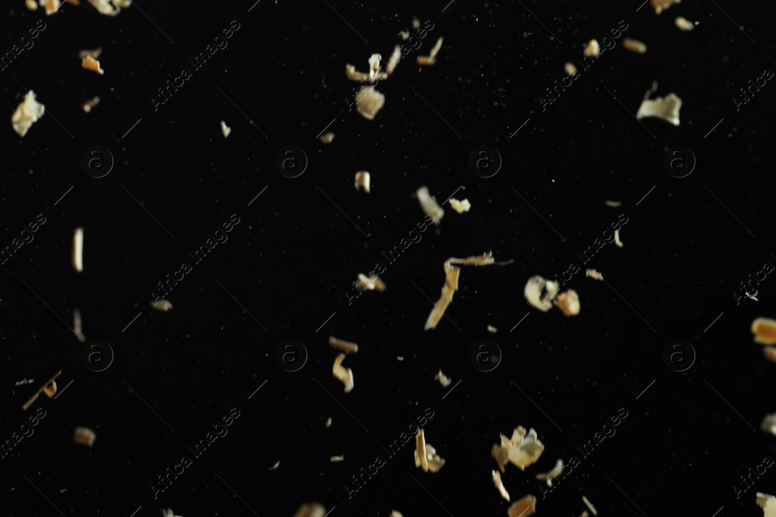 Photo of Dry natural sawdust falling on black background