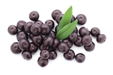 Photo of Fresh ripe acai berries and green leaves isolated on white, top view