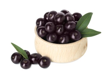 Photo of Fresh ripe acai berries in bowl and green leaves isolated on white