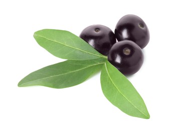 Photo of Fresh ripe acai berries and green leaves isolated on white