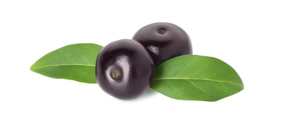 Fresh ripe acai berries and green leaves isolated on white