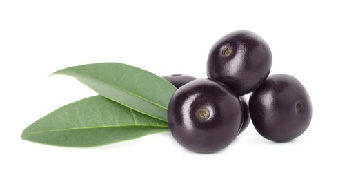 Photo of Fresh ripe acai berries and green leaves isolated on white