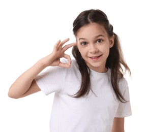 Portrait of beautiful girl showing Ok gesture on white background