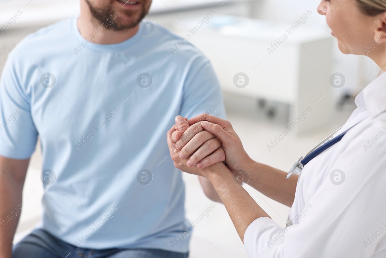 Photo of Professional doctor working with patient in hospital, closeup