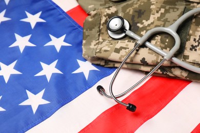 Stethoscope and military uniform on USA flag, closeup