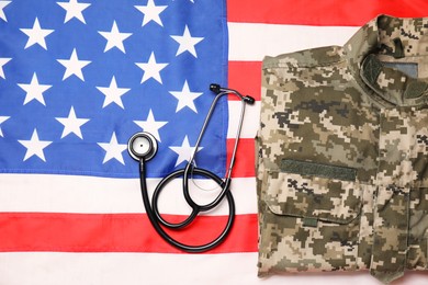 Stethoscope and military uniform on USA flag, top view