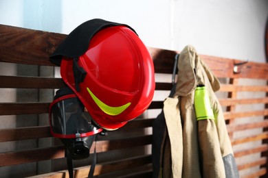 Photo of Firefighter`s uniform, helmet and mask at station