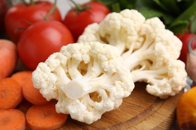 Photo of Cooking tasty stew. Cauliflower, tomatoes and carrot on table, closeup