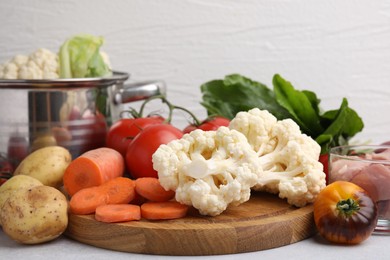 Photo of Different vegetables and raw meat for stew on light grey table