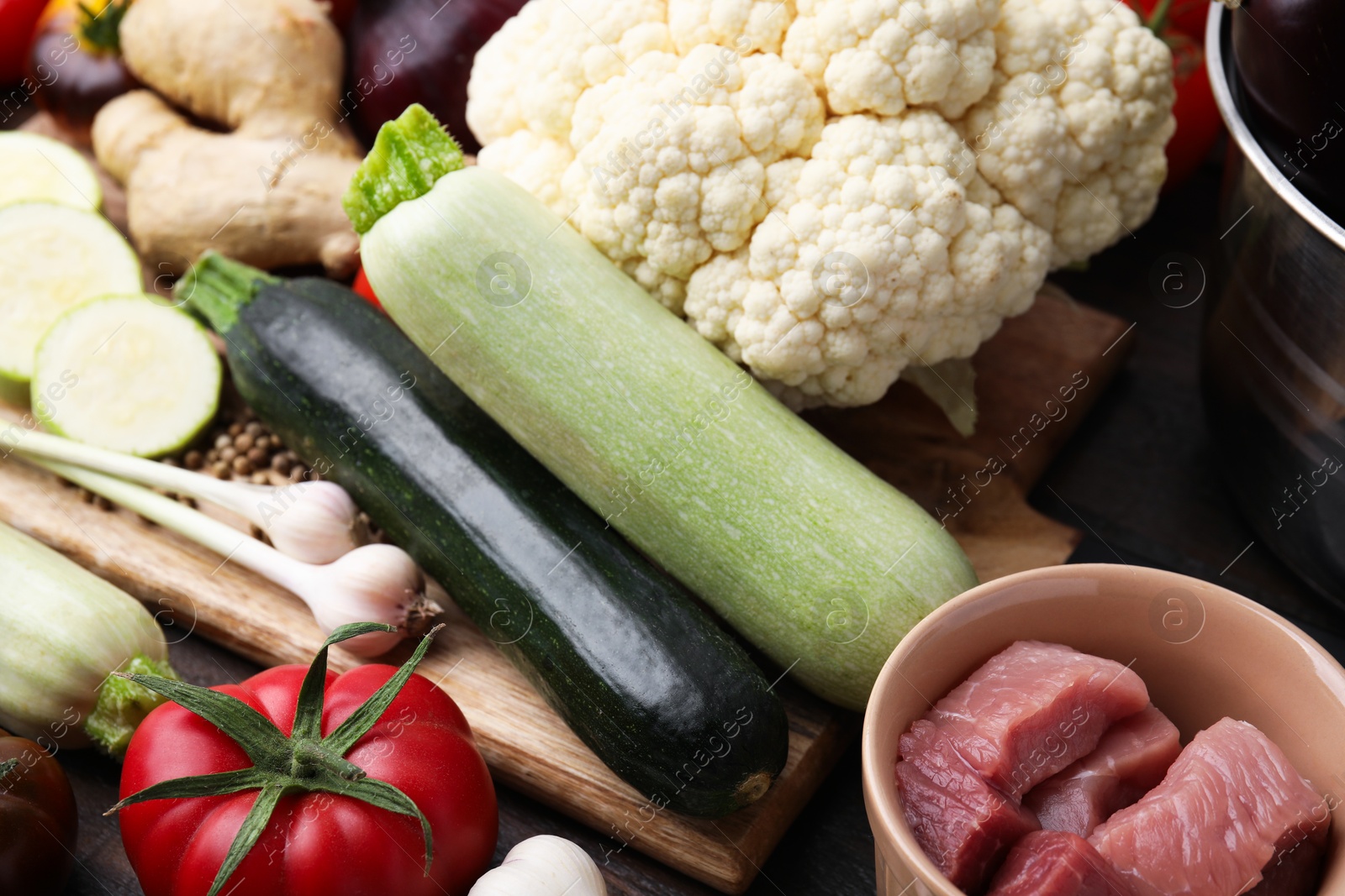 Photo of Cooking tasty stew. Fresh vegetables and raw meat on table