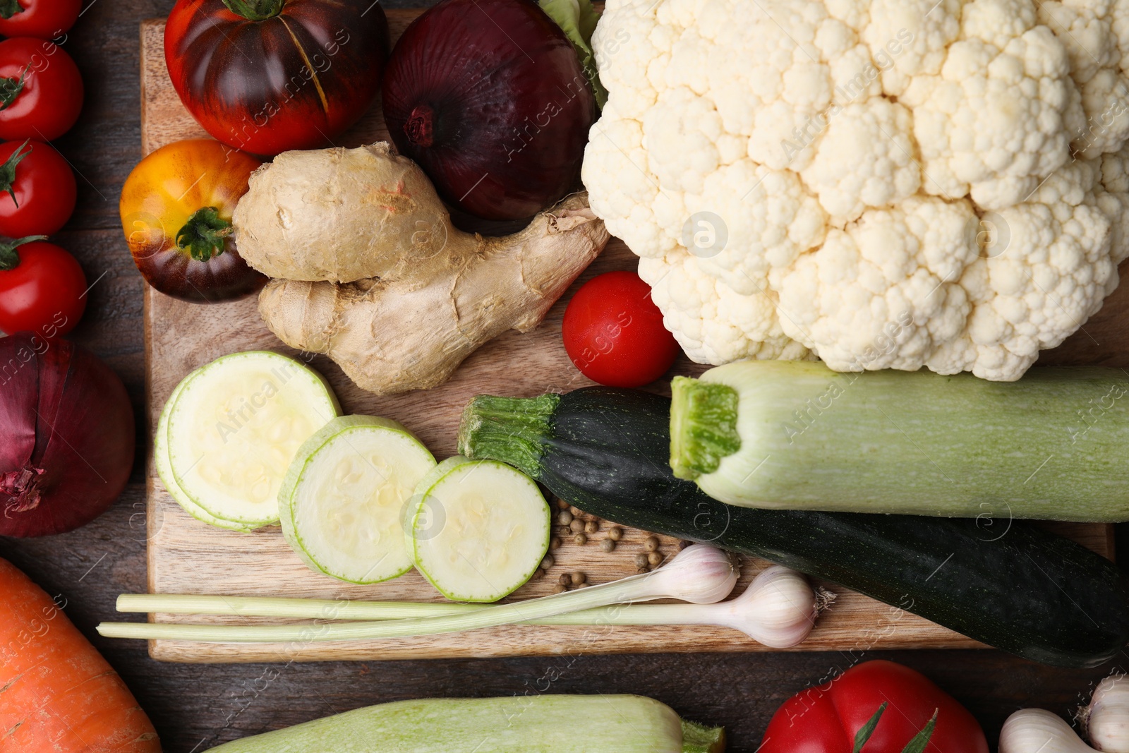 Photo of Cooking tasty stew. Fresh vegetables on wooden table, top view