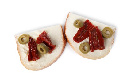 Delicious bruschettas with ricotta cheese, sun dried tomatoes and olives isolated on white, top view