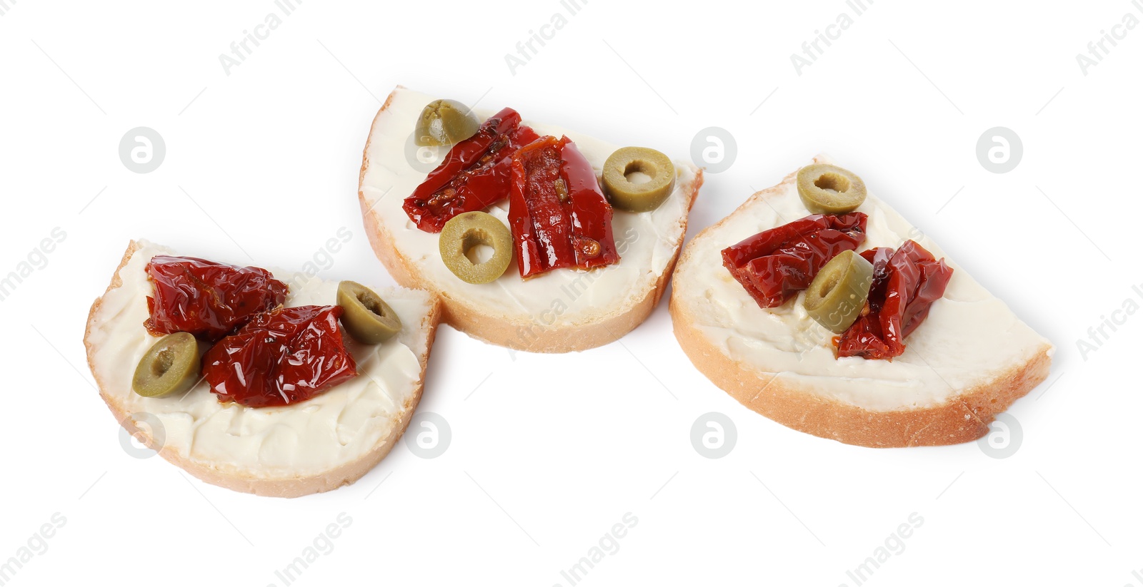 Photo of Delicious bruschettas with ricotta cheese, sun dried tomatoes and olives isolated on white