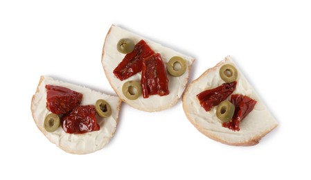 Delicious bruschettas with ricotta cheese, sun dried tomatoes and olives isolated on white, top view