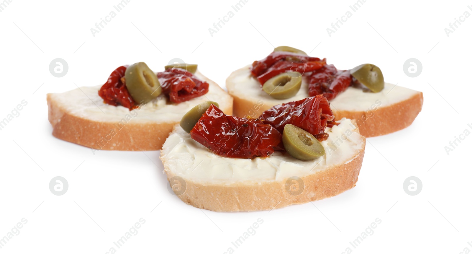 Photo of Delicious bruschettas with ricotta cheese, sun dried tomatoes and olives isolated on white